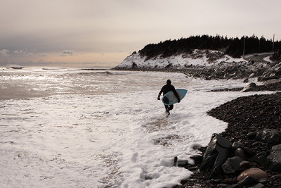 A surfer at Lawrencetown Beach